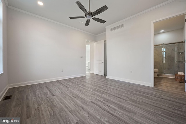 unfurnished bedroom with crown molding, dark wood-type flooring, connected bathroom, and ceiling fan