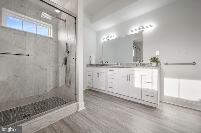 bathroom with vanity, wood-type flooring, and walk in shower