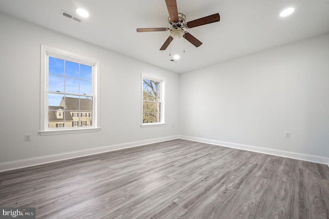 spare room with hardwood / wood-style flooring and ceiling fan