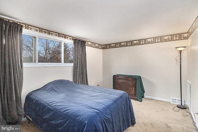 bedroom with light colored carpet