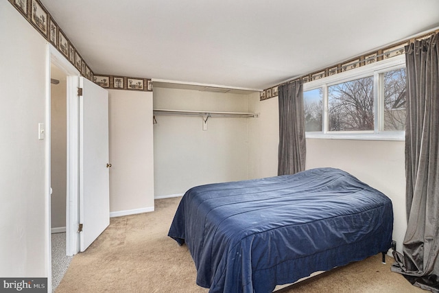 bedroom with light colored carpet and a closet