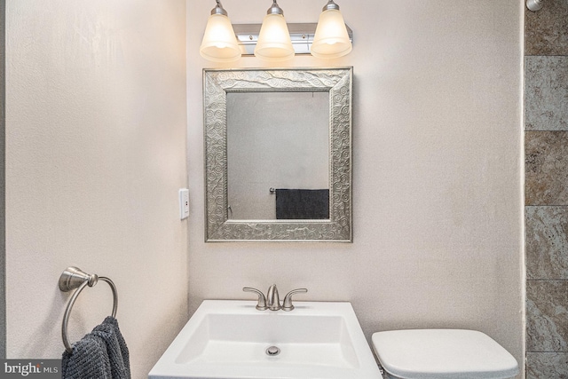 bathroom with toilet and sink