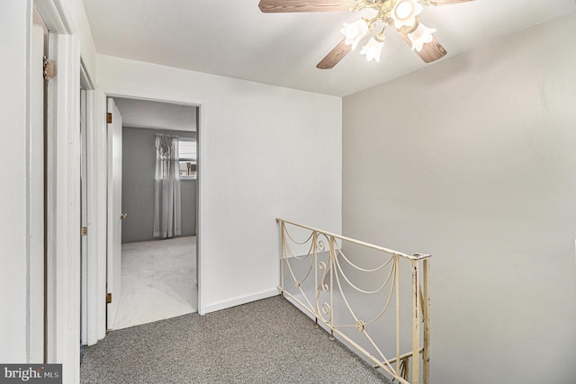 hall with dark colored carpet