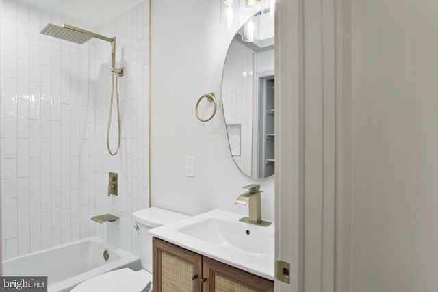 full bathroom featuring vanity, tiled shower / bath combo, and toilet