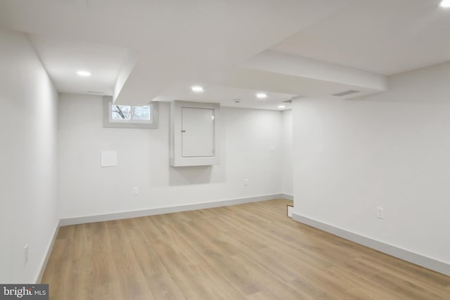 basement with light hardwood / wood-style floors