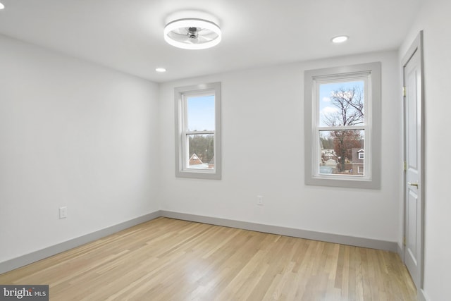 unfurnished room with plenty of natural light and light hardwood / wood-style flooring