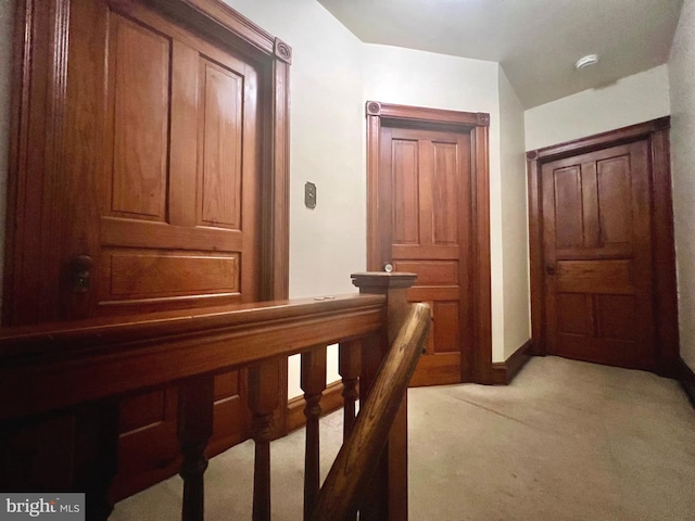 hallway featuring light colored carpet