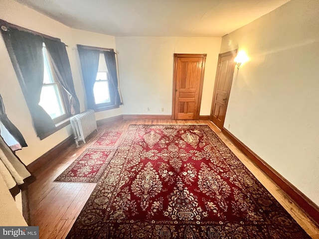 interior space featuring hardwood / wood-style flooring and radiator heating unit