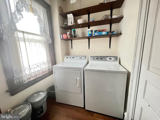 clothes washing area with dark wood-type flooring and washing machine and clothes dryer