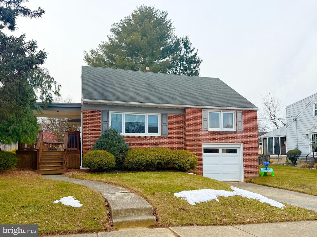 view of front of house with a garage and a front yard