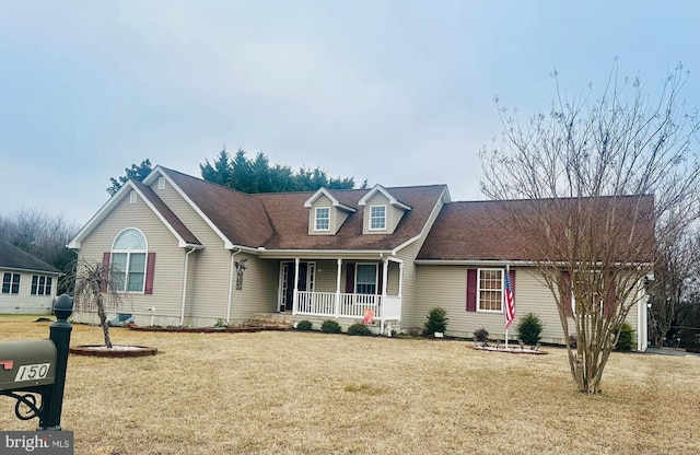 cape cod-style house featuring a porch and a front lawn