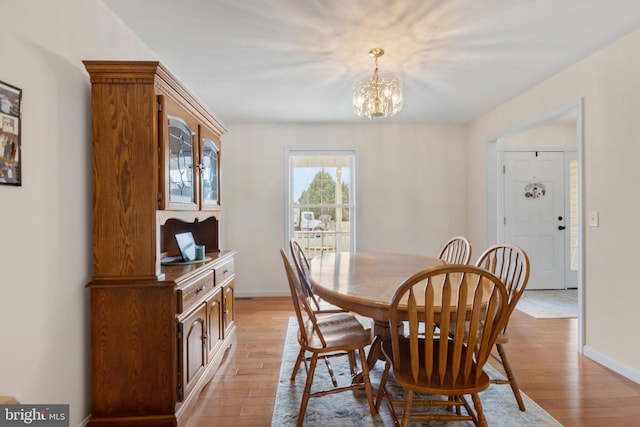 dining area with a chandelier and light wood-type flooring