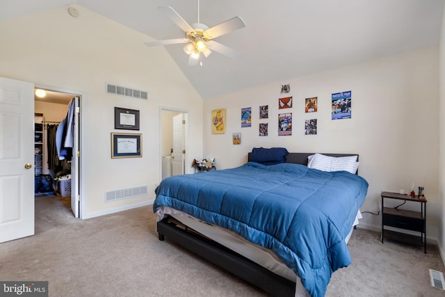 carpeted bedroom featuring a walk in closet, high vaulted ceiling, a closet, and ceiling fan