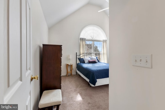 bedroom with lofted ceiling and light colored carpet