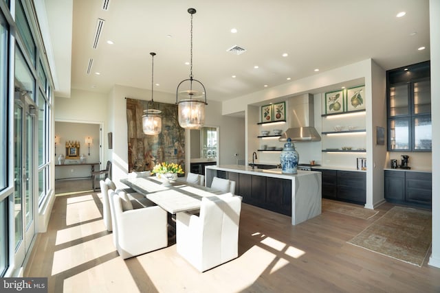 dining space with sink and light wood-type flooring