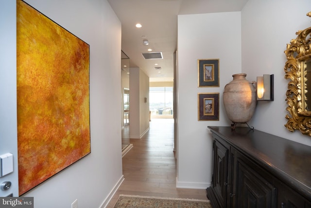 hall with hardwood / wood-style flooring