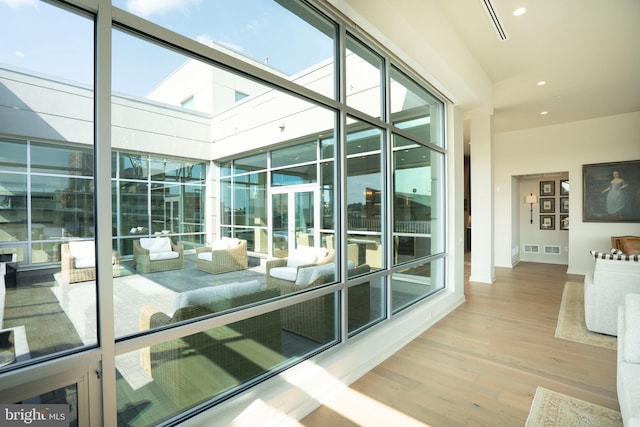 interior space with hardwood / wood-style flooring and expansive windows