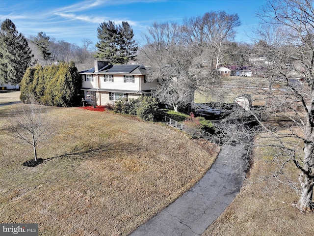 view of front facade with a front yard and solar panels