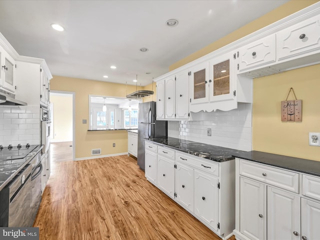 kitchen with light hardwood / wood-style flooring, black appliances, and white cabinets