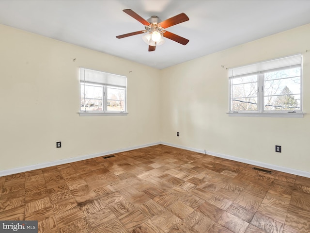 empty room featuring light parquet floors and ceiling fan