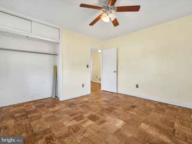 unfurnished bedroom featuring parquet floors, a closet, and ceiling fan