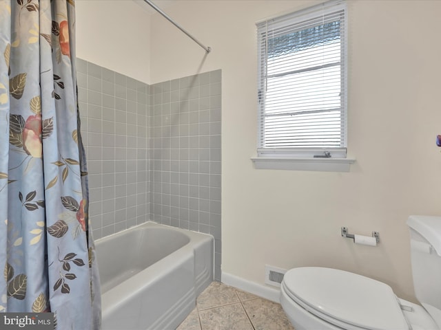 bathroom with shower / tub combo with curtain, tile patterned floors, and toilet