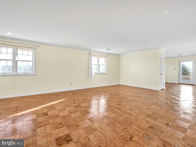 spare room featuring light parquet flooring and plenty of natural light