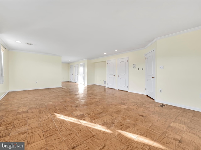 spare room with ornamental molding and light parquet floors