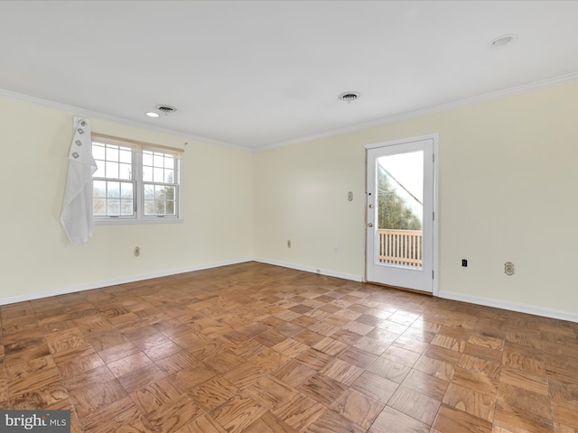 spare room featuring parquet floors, a wealth of natural light, and ornamental molding