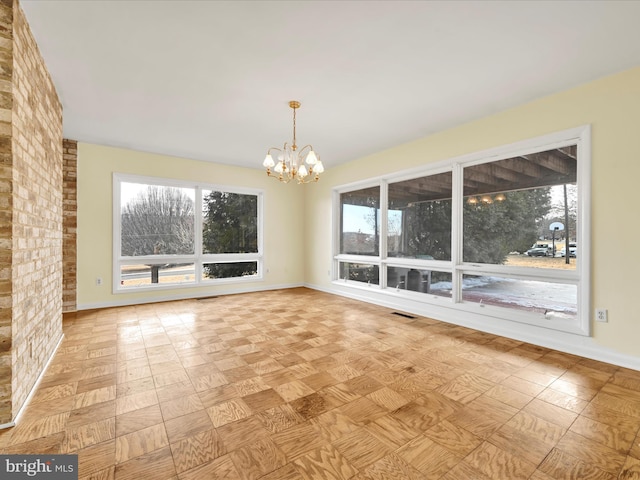 unfurnished dining area featuring a notable chandelier