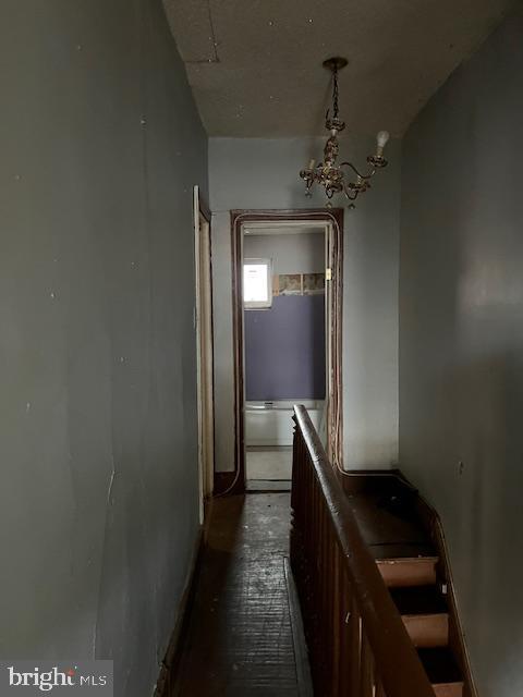 hallway featuring a notable chandelier