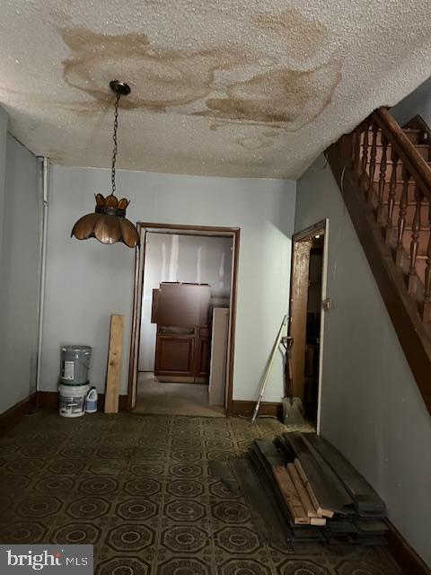 hallway with a textured ceiling