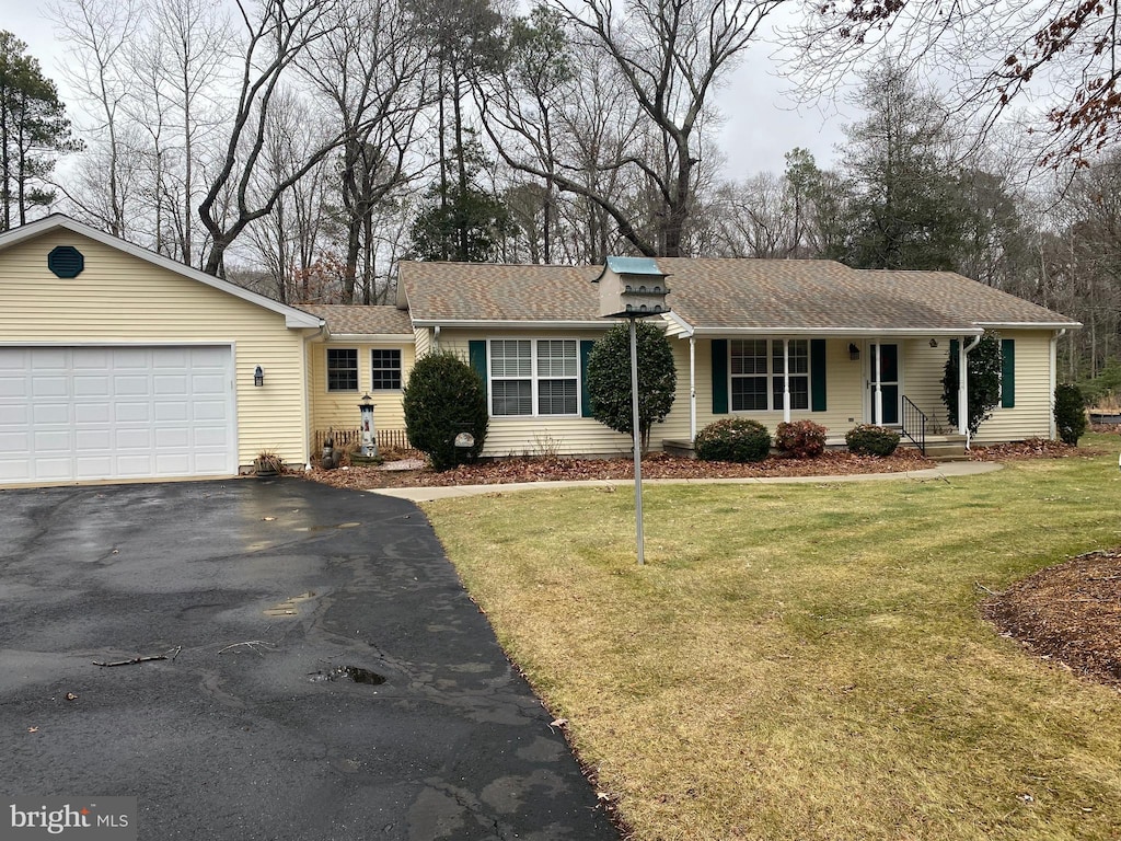 single story home with a garage and a front yard