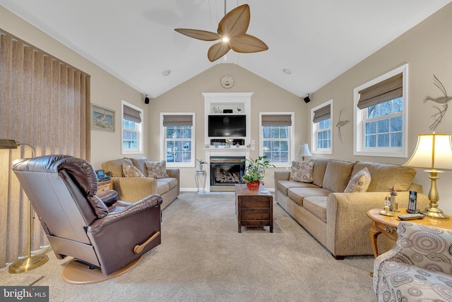 living room featuring lofted ceiling, a healthy amount of sunlight, light carpet, and ceiling fan