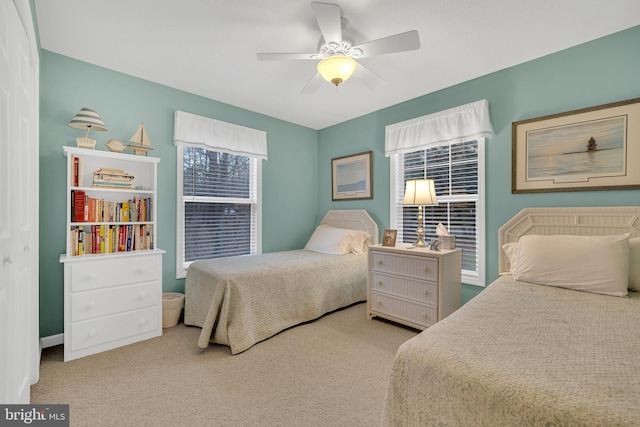 bedroom featuring light carpet and ceiling fan