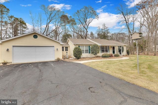 single story home with a garage and a front lawn