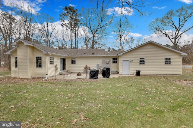 back of house featuring a patio area and a lawn