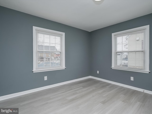 empty room with a healthy amount of sunlight and light wood-type flooring