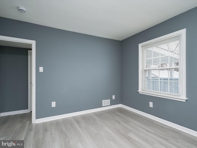 spare room featuring light wood-type flooring