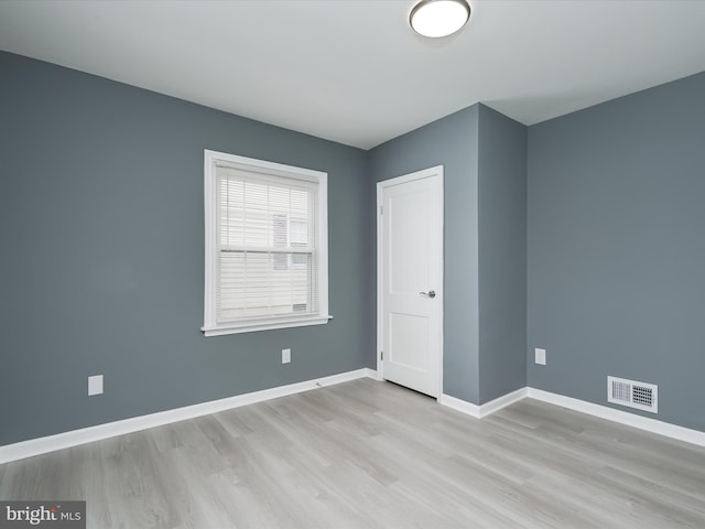 spare room featuring light hardwood / wood-style floors