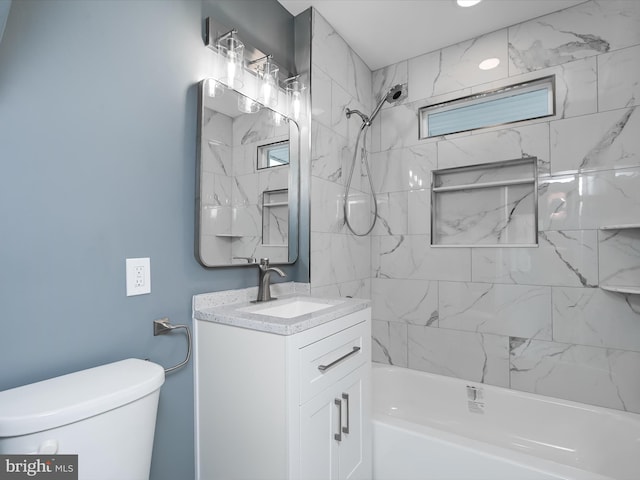 full bathroom with tiled shower / bath, vanity, and toilet