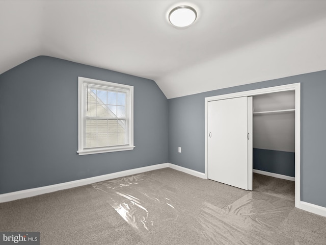 additional living space with lofted ceiling and light colored carpet