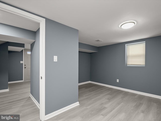 basement with light hardwood / wood-style floors