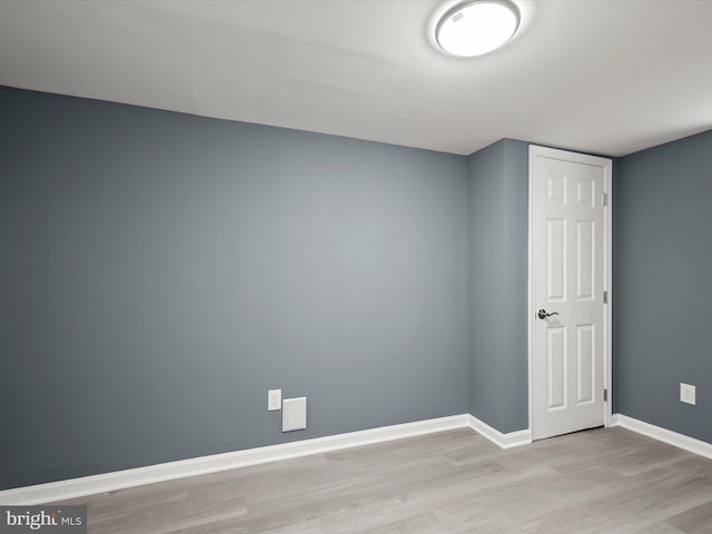 spare room featuring light wood-type flooring