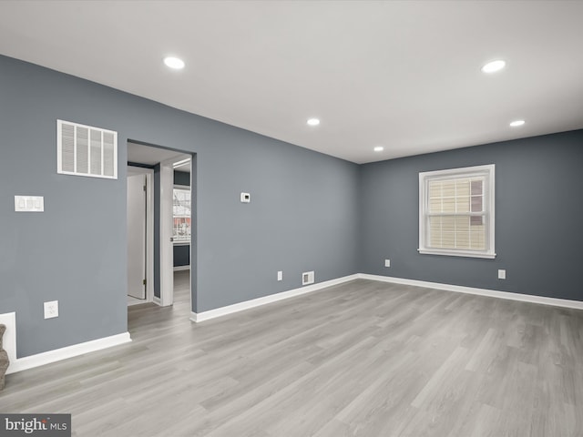 empty room featuring light hardwood / wood-style flooring and a healthy amount of sunlight