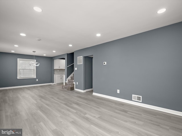 unfurnished living room featuring light hardwood / wood-style floors