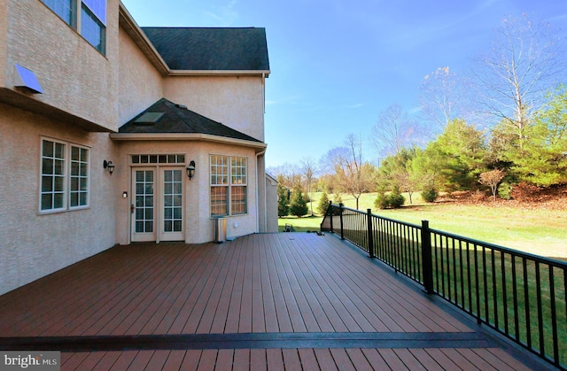 wooden deck with a lawn