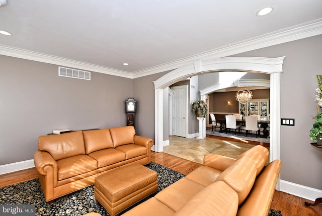 living room with crown molding and wood-type flooring