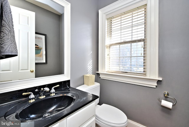 bathroom featuring vanity and toilet