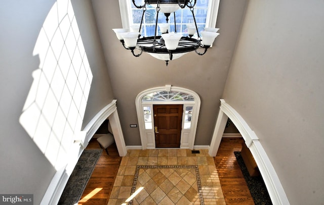 foyer featuring a notable chandelier and dark hardwood / wood-style floors